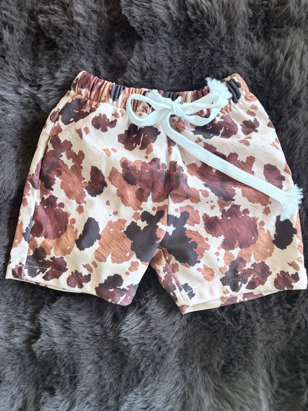 Brown cow print baby boy swim trunks size 12-18months